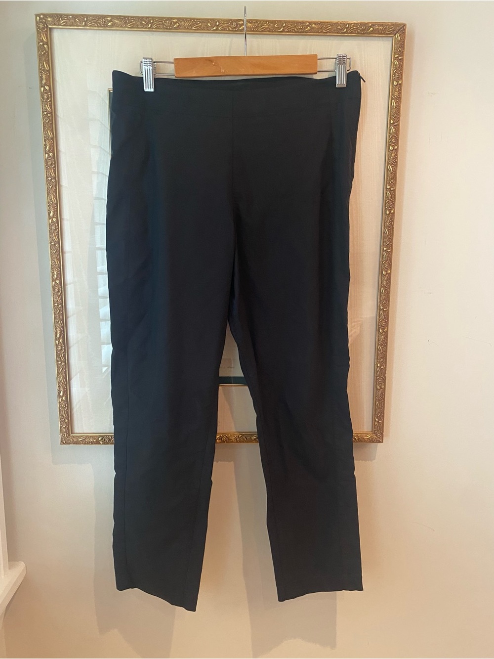 black straight-leg and tapered trousers with smooth, minimal waistbands. Size 10